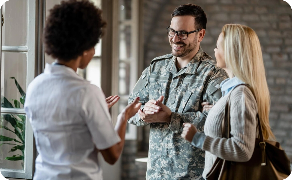 A veteran and his wife having conversations with a woman
