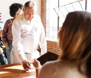 business-meeting-with-document-signing-recertion-desk-us-election-station-us-election-day-us-election-day-people-vote-american-democracy_53876-1089786 - VA Loans Florida document signing